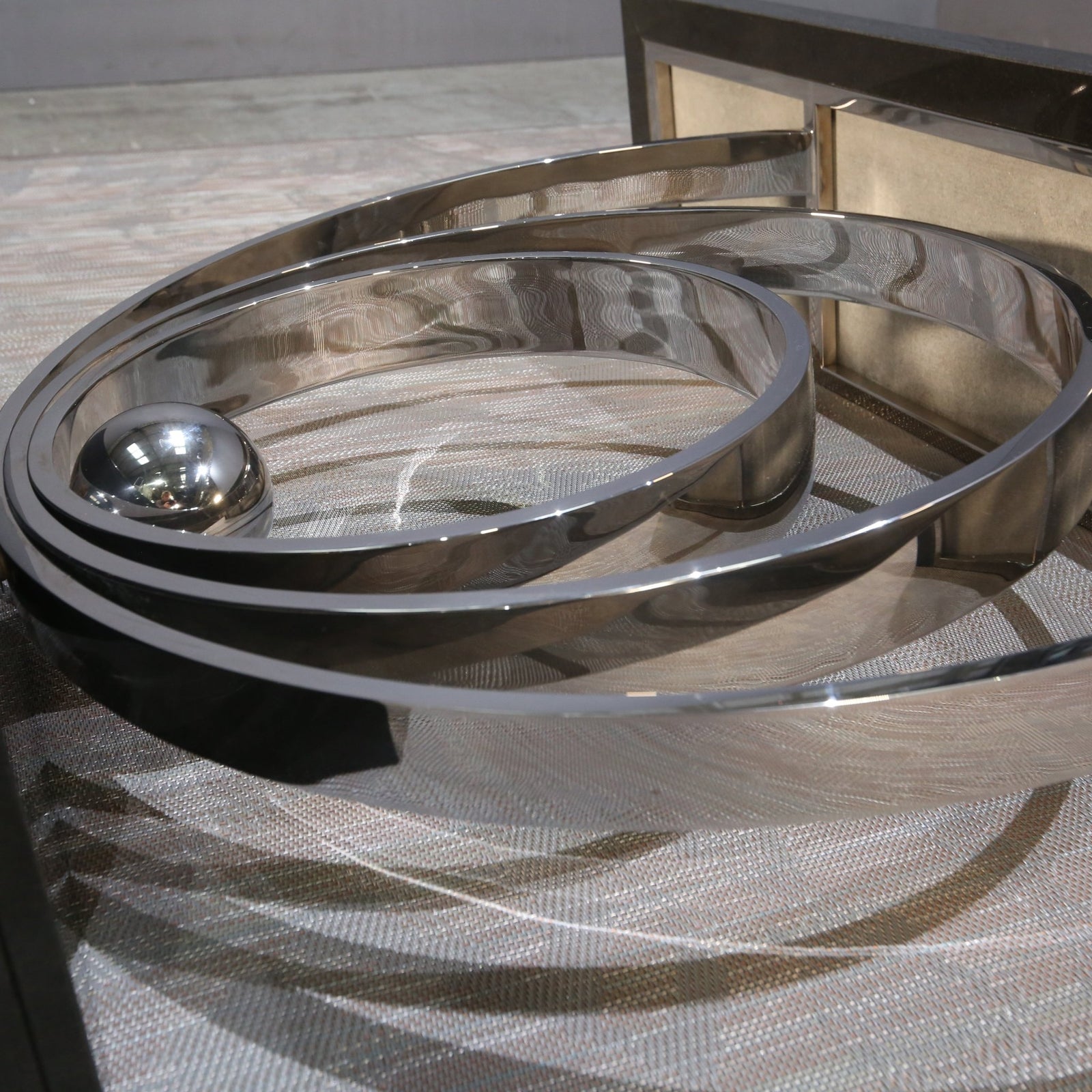 Decorus Ammonite Console Table in Polished Stainless Steel with Black Granite Top @ REHAUS