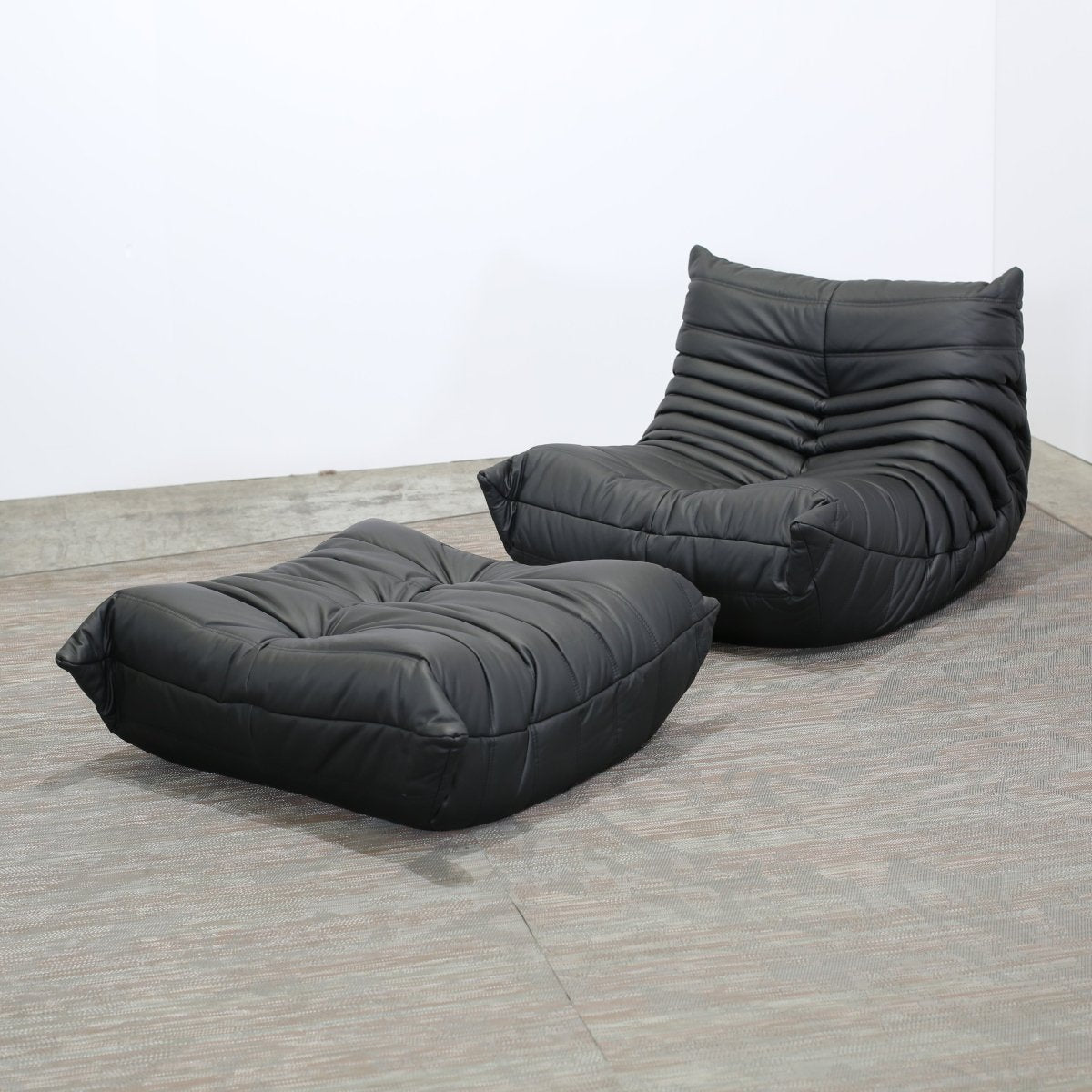 Ligne Roset Black Leather Togo Armchair and Footstool by Michel Ducaroy, Set of Two @ REHAUS
