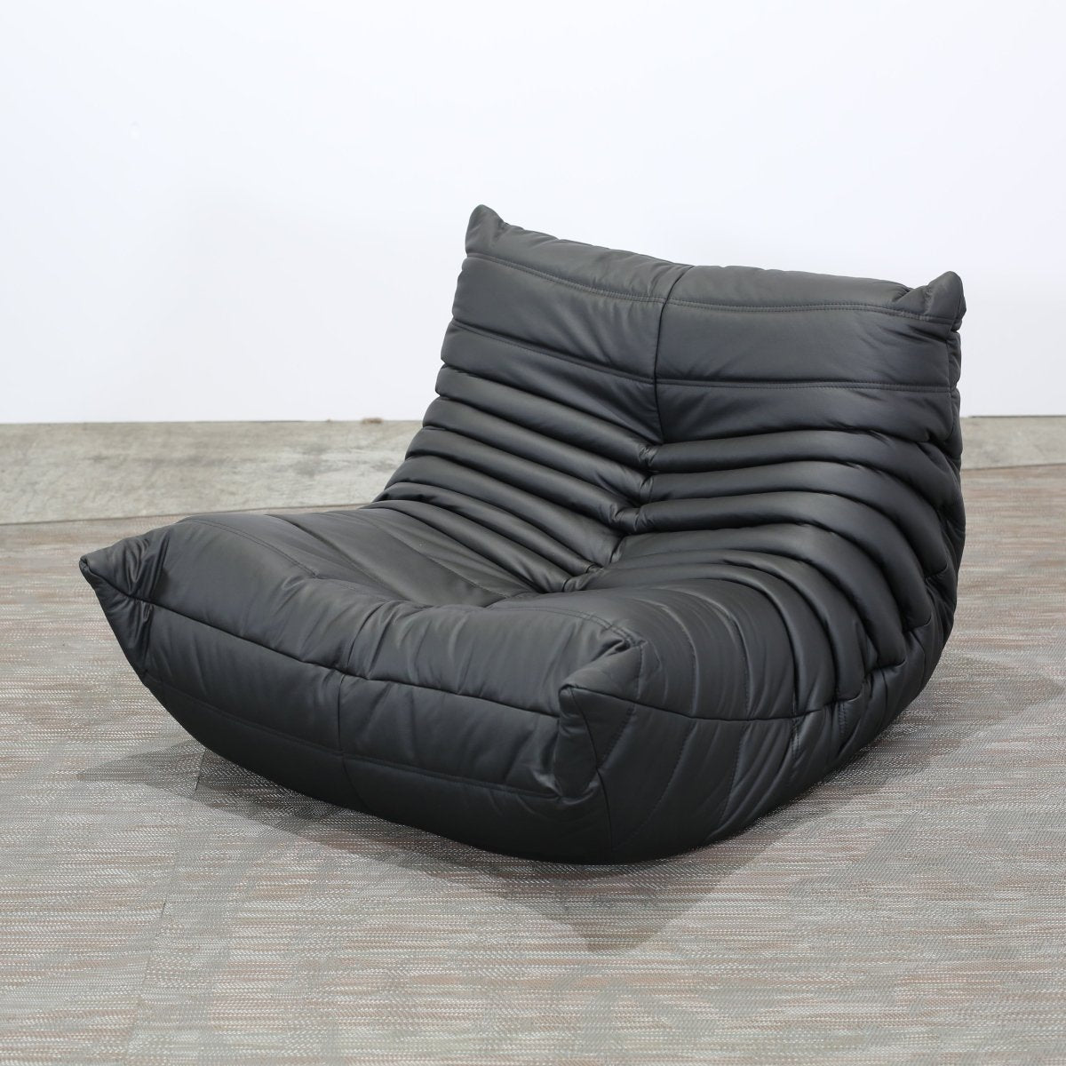 Ligne Roset Black Leather Togo Armchair and Footstool by Michel Ducaroy, Set of Two @ REHAUS